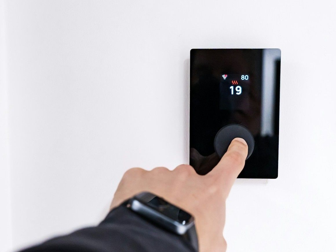 Hand adjusting a smart wall control panel